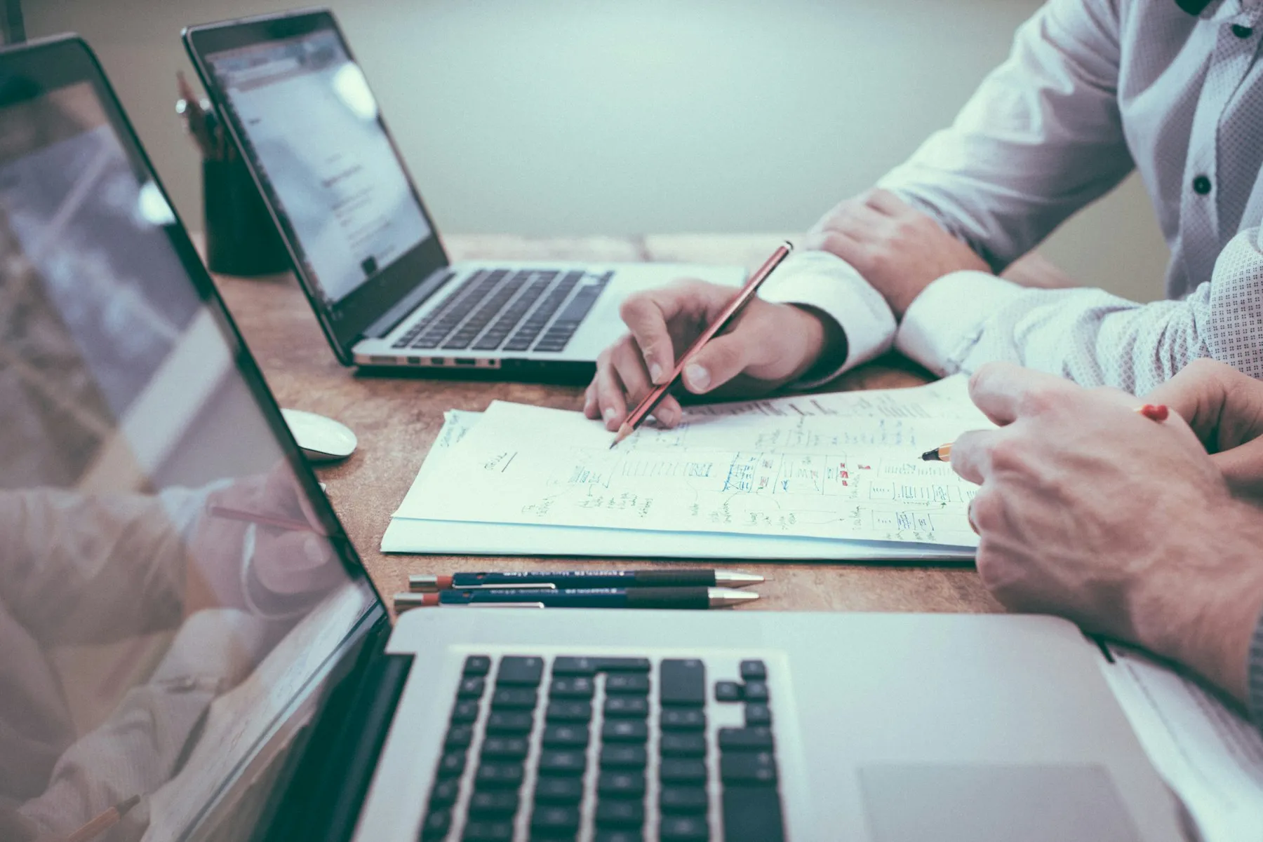 People reviewing documents at an office desk